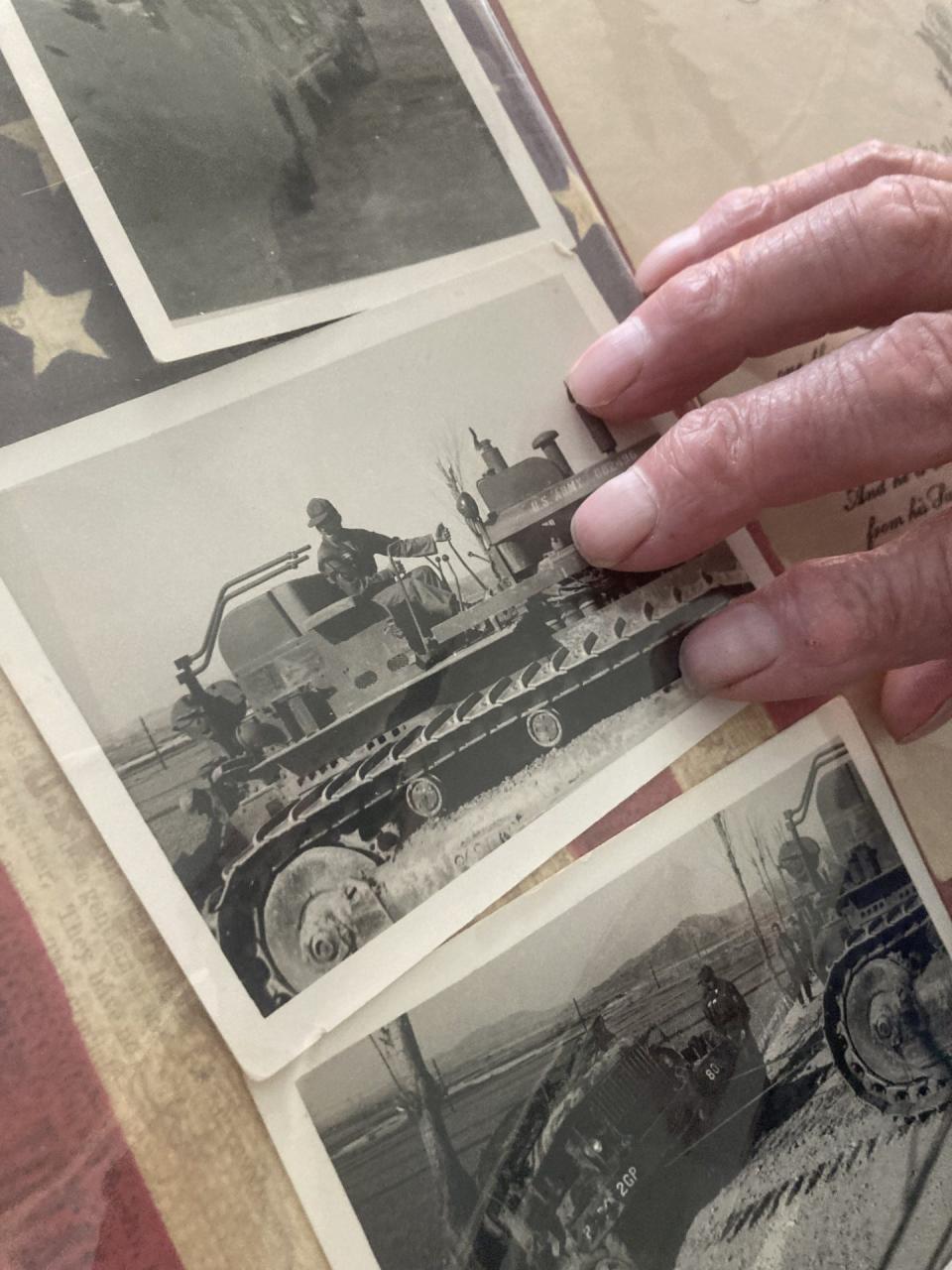 Retired Sgt. 1st Class Herbert Getchel points to a photo of himself in Korea on a bulldozer  that was used to flip another bulldozer that overturned  because another soldier veered off the road to avoid a civilian Korean bus.