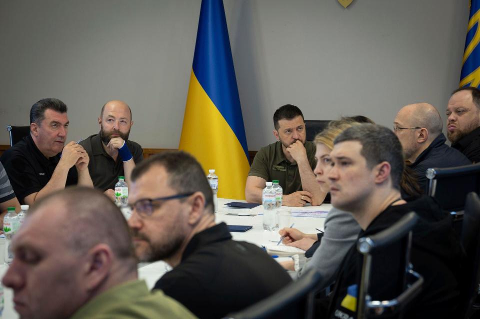 In this photo provided by the Ukrainian Presidential Press Office, Ukrainian President Volodymyr Zelenskyy, center, chairs the emergency meeting of the National Security and Defense Council on the situation at the Kakhovka HPP after the dam was blown up overnight, in Kyiv, Ukraine, Tuesday, June 6, 2023. (Ukrainian Presidential Office via AP)