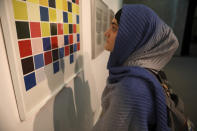 A visitor looks at artworks by the American artist Sol Lewitt while visiting a 19th and 20th-century American and European minimalist and conceptual masterpieces show at the Tehran Museum of Contemporary Art in Tehran, Iran, Tuesday, Aug. 2, 2022. Some of the world’s most prized works of contemporary Western art have been unveiled for the first time in decades — in Tehran. (AP Photo/Vahid Salemi)