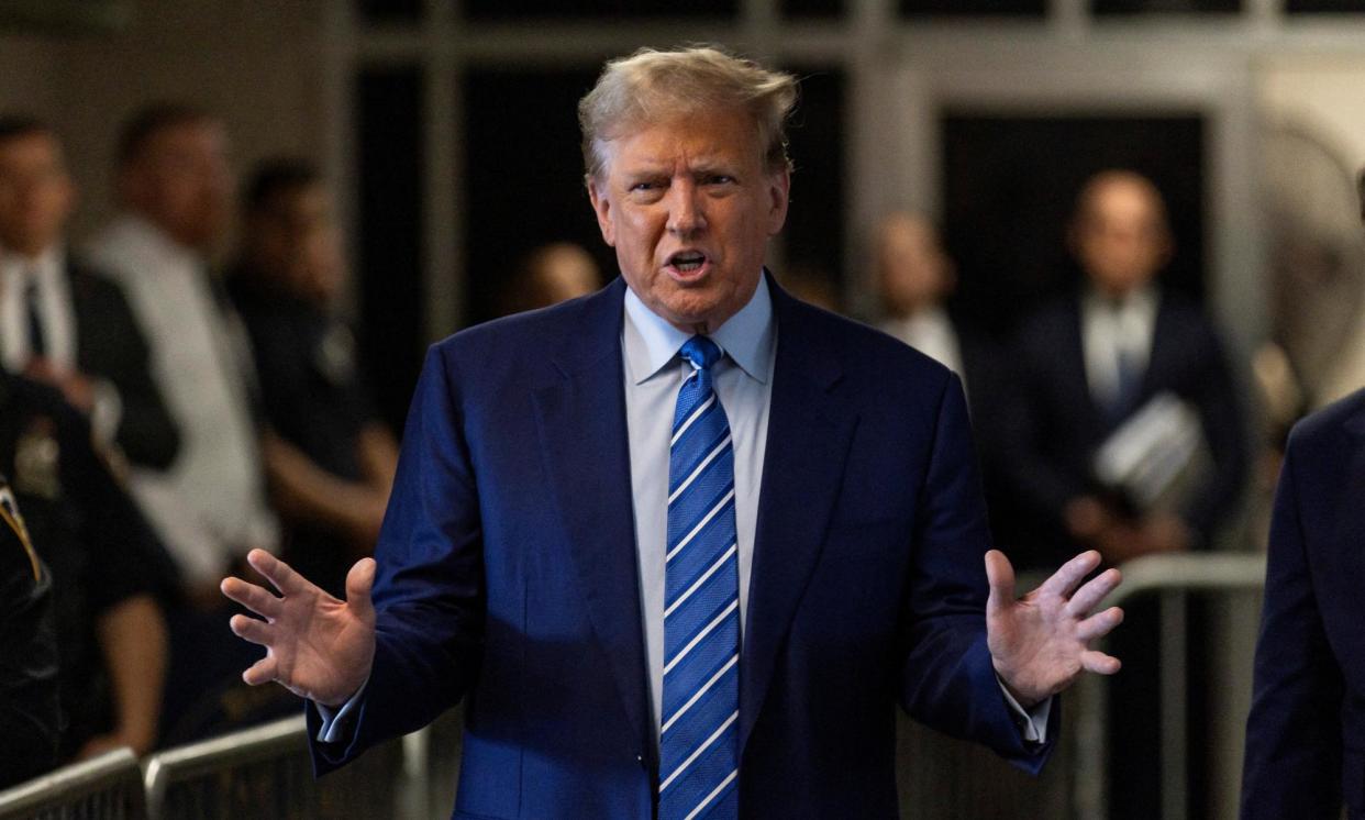 <span>Donald Trump talks with reporters as he arrives for the start of the second day of his trial in Manhattan </span><span>Photograph: Justin Lane/Reuters</span>