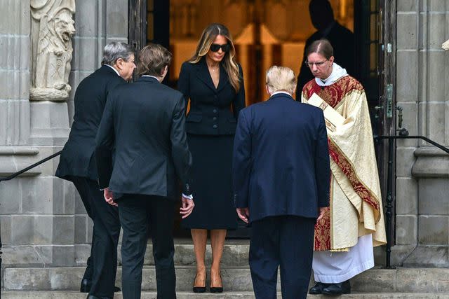 <p>GIORGIO VIERA/AFP via Getty</p> Melania, Donald, and Barron Trump, along with Viktor Knavs, attend the funeral of Amalija Knavs