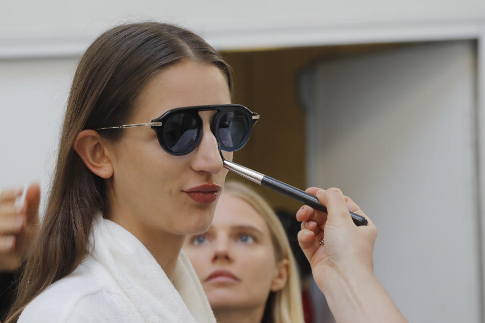 A model is made up backstage prior to the Sacai mens Spring-Summer 2020 fashion collection presented in Paris, Saturday, June 22 2019. (AP Photo/Michel Euler)