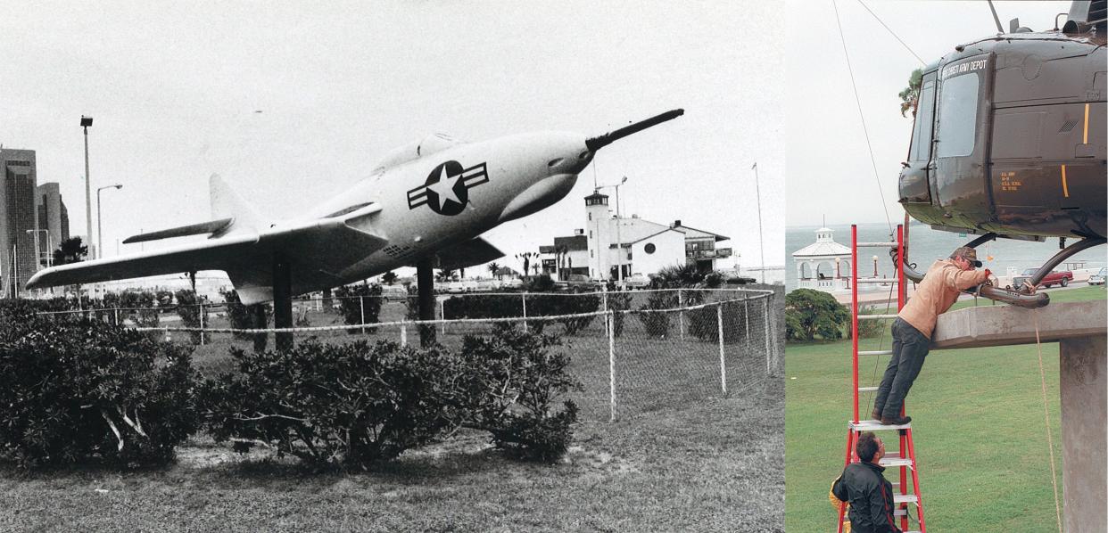 LEFT: The F-9 Cougar jet on display on the Lawrence Street T-head was taken down shortly after this photo was taken in March 1992. The Navy no longer had funds to maintain the jet, which was corroding in the salt air. RIGHT: A refurbished UH-1 helicopter, known as a Huey, is installed on the memorial pedestal in McCaughan Park on Nov. 11 1997. 