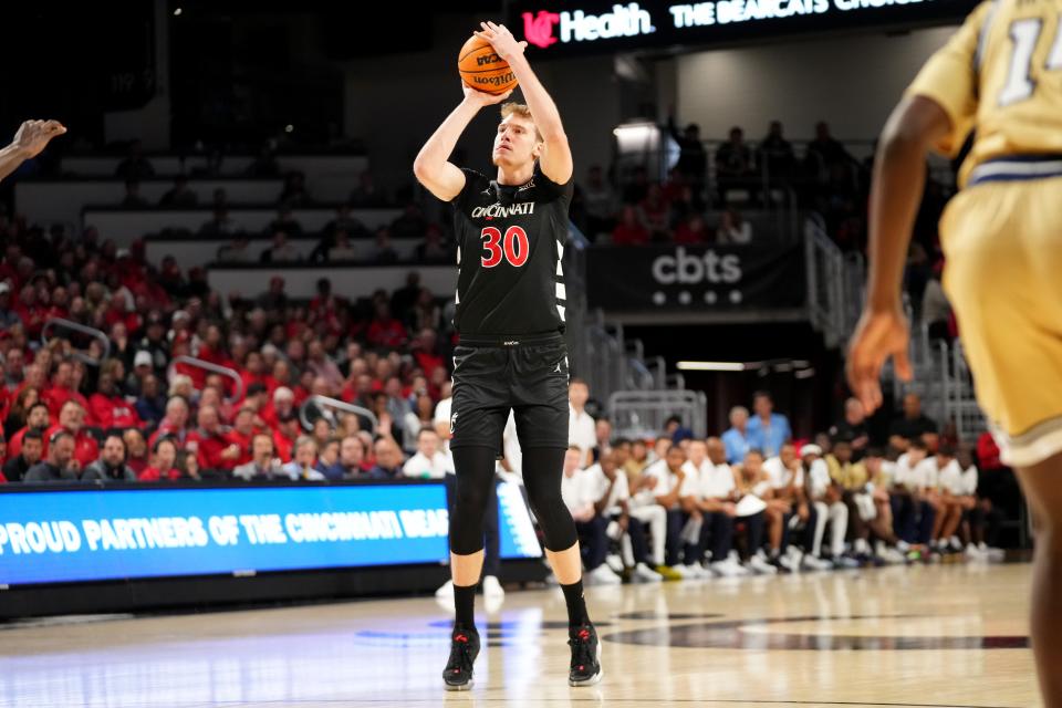 Cincinnati Bearcats forward Viktor Lakhin (30) rises for a 3-point basket against Georgia Tech Wednesday, Nov. 22. The 6-11 forward was 5-for-6 from the arc.