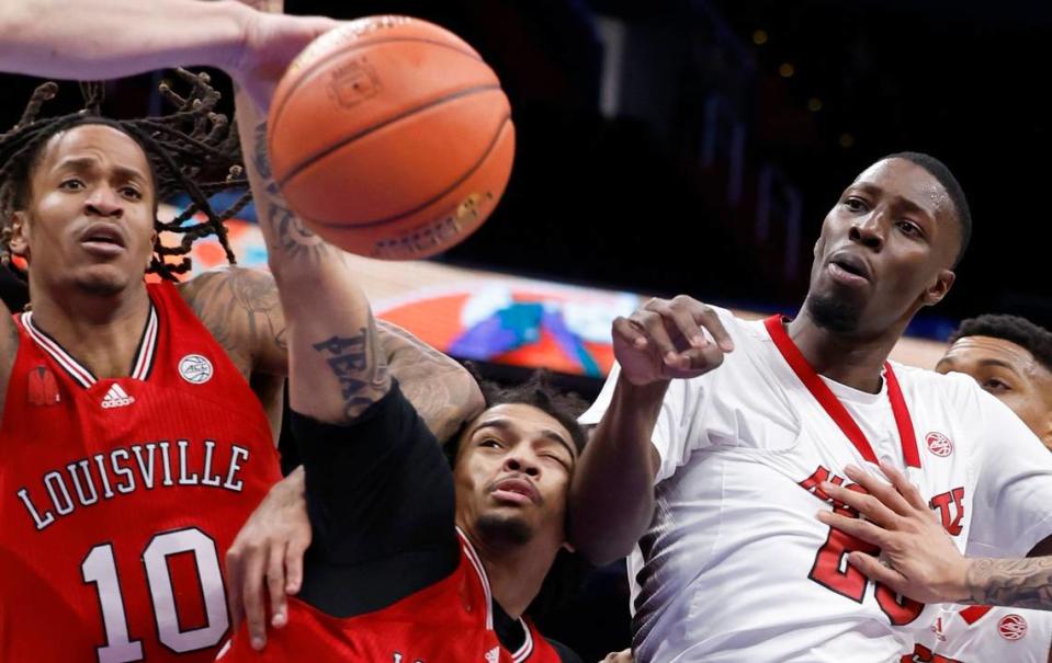 Louisville’s Kaleb Glenn (10), Skyy Clark (55) and N.C. State’s Mohamed Diarra (23) go after the loose ball during the first half of N.C. State’s game against Louisville in the first round of the 2024 ACC Men’s Basketball Tournament at Capital One Arena in Washington, D.C., Tuesday, March 12, 2024. Ethan Hyman/ehyman@newsobserver.com