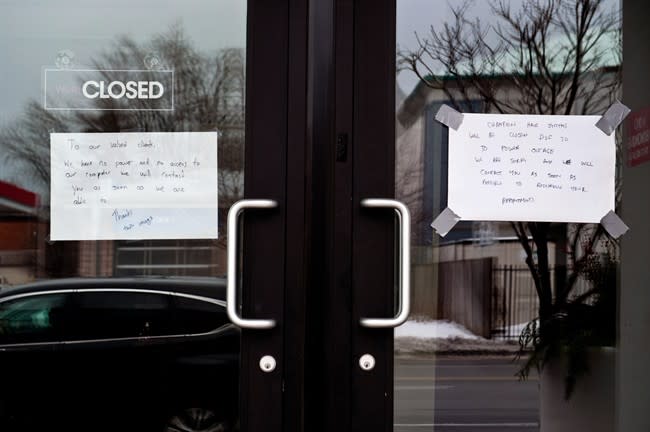 Closed businesses around Danforth and Victoria Park Avenues apologize to customers, Monday, December 23, 2013, after a severe ice storm hit Toronto. THE CANADIAN PRESS/Galit Rodan