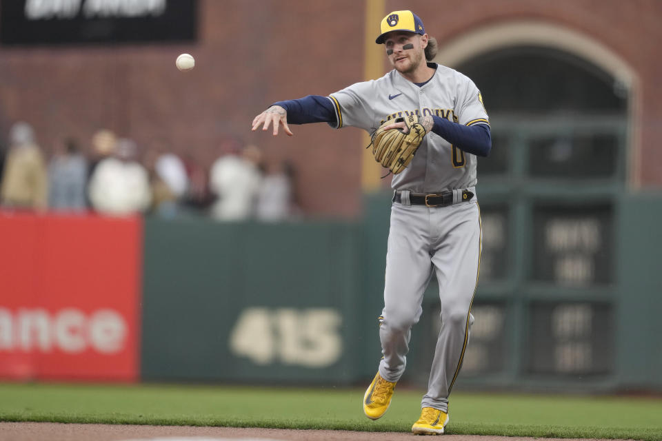 Milwaukee Brewers second baseman Brice Turang (0) throws out San Francisco Giants' LaMonte Wade Jr. at first base during the fifth inning of a baseball game in San Francisco, Saturday, May 6, 2023. (AP Photo/Jeff Chiu)