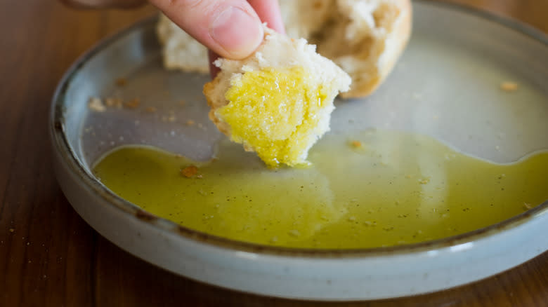 Dipping bread in olive oil