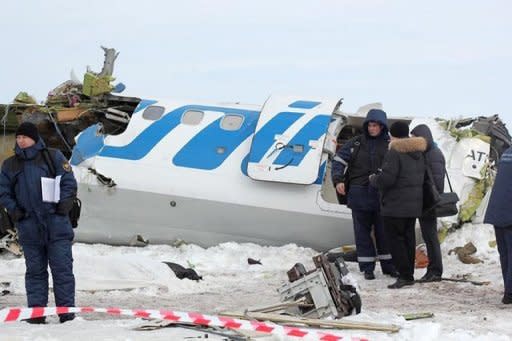 A photo provided on April 2, 2012 by the Russian Emergencies Ministry shows rescuers and investigators working at the site of a plane crash in Siberia that killed 31 people on Monday. The French-Italian made ATR-72 passenger plane run by private Russian airline UTair came down moments after takeoff some 45 km (28 miles) from the western Siberian city of Tyumen
