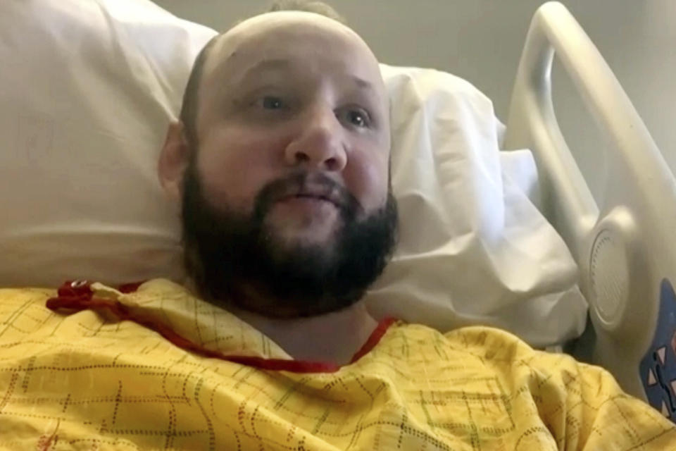 In this image taken from video, James Slaugh speaks with The Associated Press on Tuesday, Nov. 22, 2022, from his hospital bed at Penrose Hospital, in Colorado Springs, Colo. Slaugh suffered a bullet wound to his shoulder during a mass shooting at a gay club in Colorado Springs on Saturday night, Nov. 19. (AP Photo)