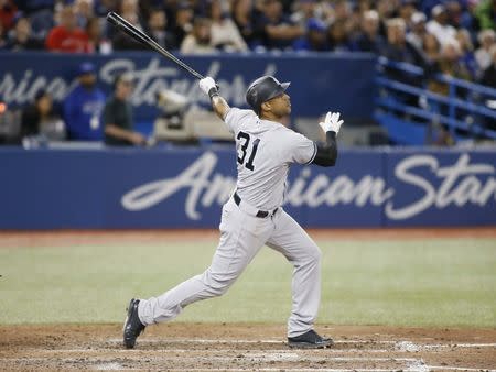 Jun 5, 2018; Toronto, Ontario, CAN; New York Yankees center fielder Aaron Hicks (31) hits a three run home run in the eighth inning against the Toronto Blue Jays at Rogers Centre. Mandatory Credit: John E. Sokolowski-USA TODAY Sports