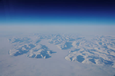 Glacial ice is seen from the window during a NASA flight to support the Oceans Melting Greenland (OMG) research mission above the east coast of Greenland, March 13, 2018. REUTERS/Lucas Jackson