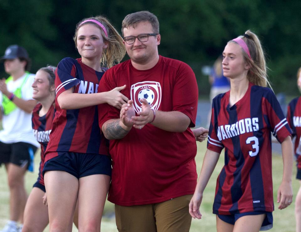 East Gaston girls soccer coach River Hawkins celebrates with players following their 7-0 win over West Wilkes on May 16, 2022.