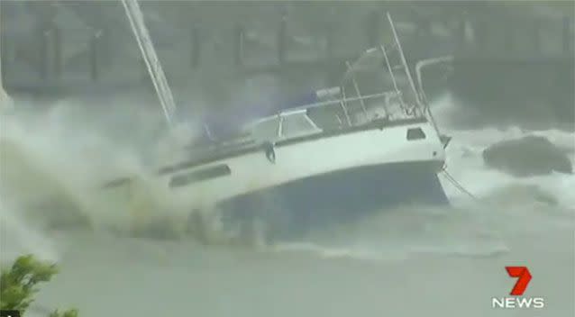 The devastation of Debbie: Yacht crashes into rocks at Abell Point Marina, Airlie Beach. Source: 7 News