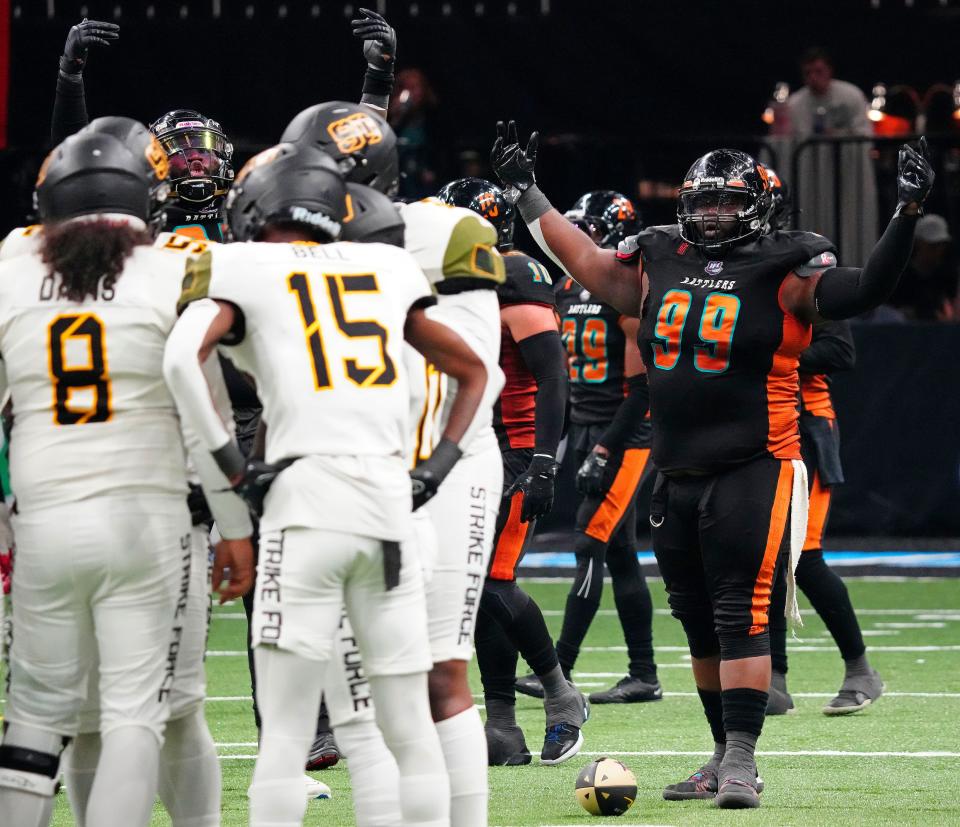 Arizona Rattlers defensive lineman Harold Love (99) pumps up the crowd against the Strike Force during a game at Footprint Center in Phoenix on June 24, 2023.