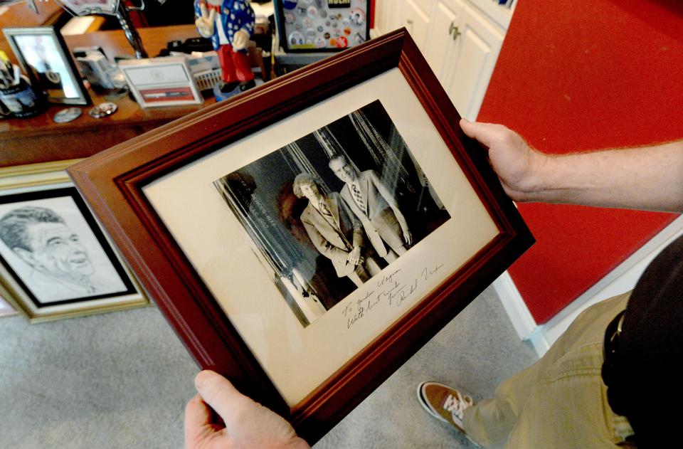 Gordon Wayman holds a photo of himself Wednesday, Sept. 13, 2023, taken when he was 18 years old with former President Richard Nixon.