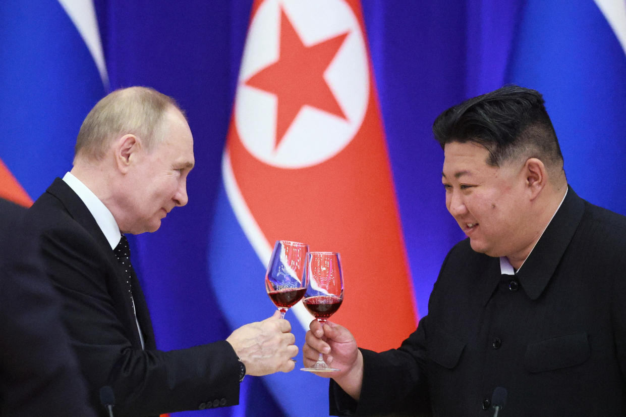 Vladimir Putin, left, and Kim Jong Un 