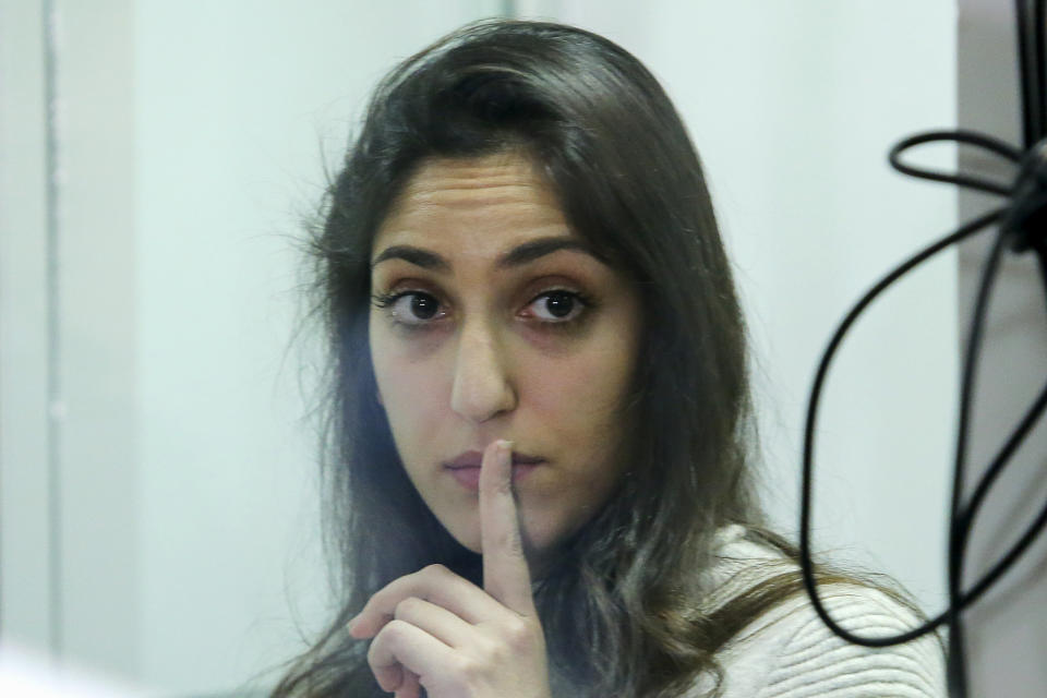 Israeli Naama Issachar gestures during an appeal hearings in a courtroom in Moscow, Russia, Thursday, Dec. 19, 2019. An Israeli backpacker serving prison time in Russia on a drug conviction is appealing her case and says she was wasn't provided a translator or lawyer after being detained at a Moscow airport. She was arrested in April in Moscow's Sheremetyevo Airport, where she was transferring flights en route from India to Israel. More than nine grams of hashish were found in her luggage. She was later sentenced to 7 1/2 years. (AP Photo/Alexander Zemlianichenko Jr.)