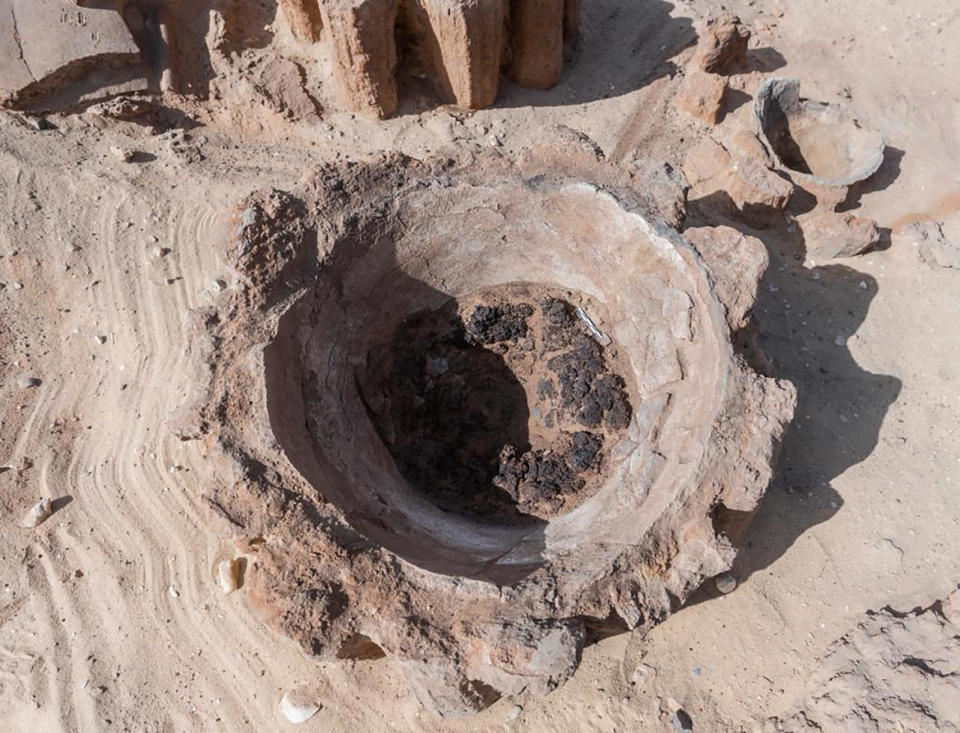 This photo provided by the Egyptian Antiquities Ministry on Saturday, Feb. 13, 2021 show a pottery basin, which archaeologists say had been used to heat up a mixture of grains and water to produce beer, in Abydos, some 450 km (280 miles) south of Cairo, Egypt. The basins were part of what could be the oldest known beer factory unearthed in Abydos, an ancient burial ground dating back to the region of King Narmer, the last king of the Predynastic Period (6000 - 3150 B.C.), according to Mostafa Waziri, secretary general of the Supreme Council of Antiquities. (Egyptian Antiquities Ministry via AP)