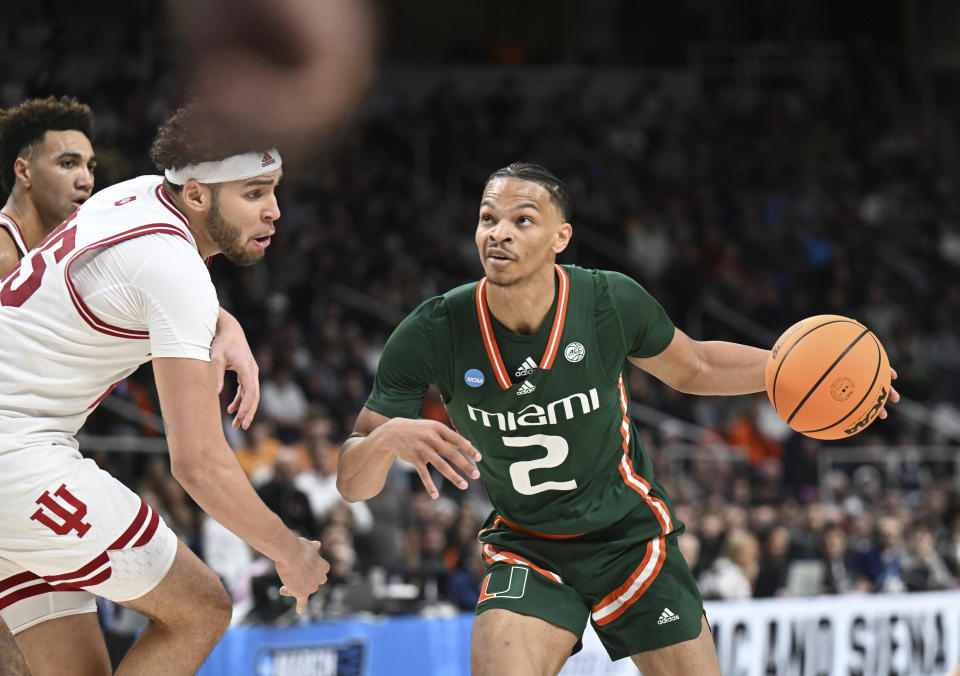 Miami guard Isaiah Wong (2) moves the ball afgainst Indiana during the second half of a second-round college basketball game in the men's NCAA Tournament on Sunday, March 19, 2023, in Albany, N.Y. (AP Photo/Hans Pennink)