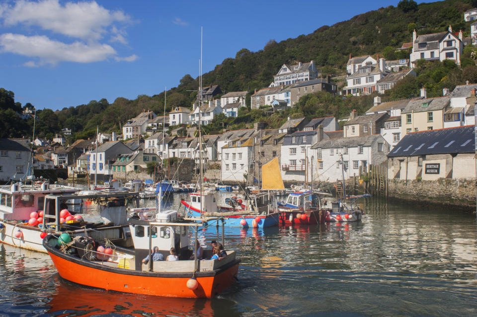 Polperro, Cornwall, UK - July 5th, 2019: Tourists enjoying the summer sunshine at Polperro, Cornwall. Polperro is one of the most popular travel destinations in south west England.