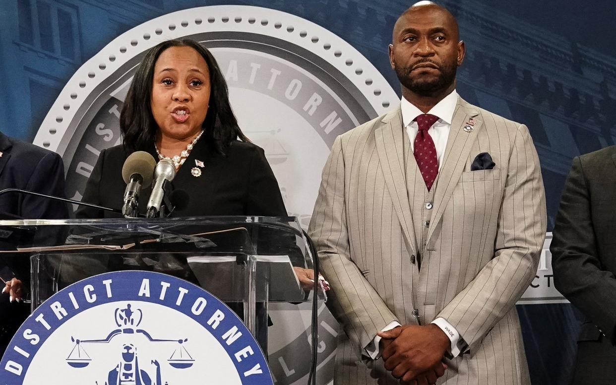 Fulton County District Attorney Fani Willis alongside Nathan Wade at a press conference  last year