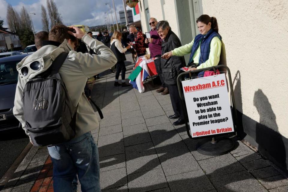 Members of the No!Cymru anti Welsh independence group handing out flyers before the match against Salford City