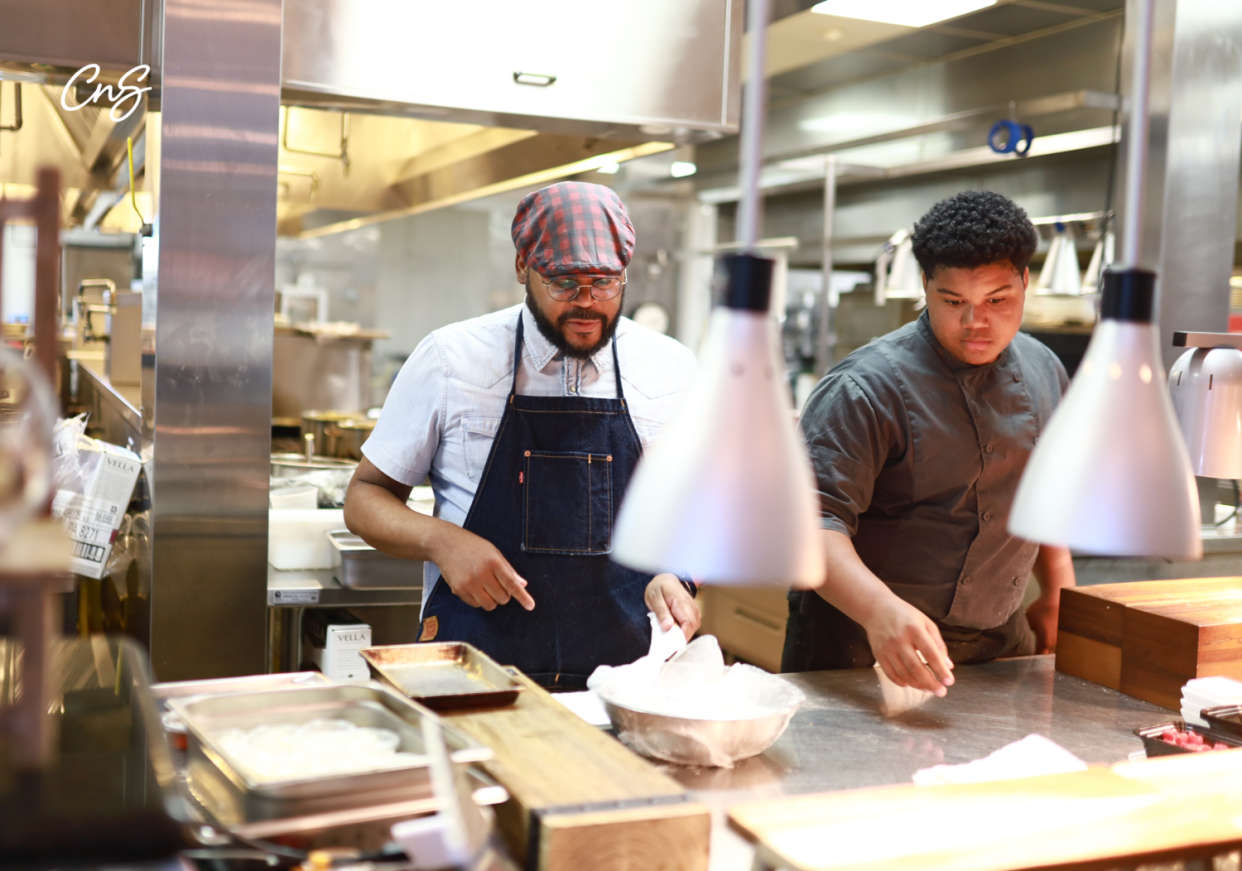 Sean Rush (left), vice president of the Shular Institute, works with the crew in the kitchen. Rush is from Milwaukee, and he's helping bring the Atlanta-based institute's culinary teaching to the city.