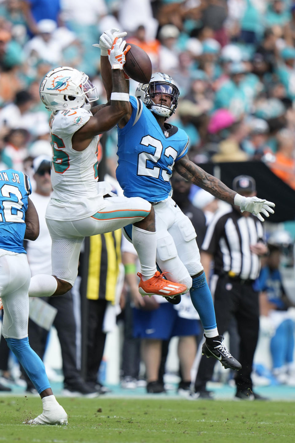 Carolina Panthers cornerback CJ Henderson (23) defends Miami Dolphins running back Salvon Ahmed (26) during the second half of an NFL football game, Sunday, Oct. 15, 2023, in Miami Gardens, Fla. (AP Photo/Wilfredo Lee)