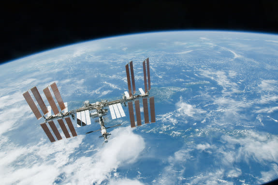 The International Space Station flies above Earth in 2010. Two crewmembers will launch to the orbiting outpost on a one-year mission in March 2015.