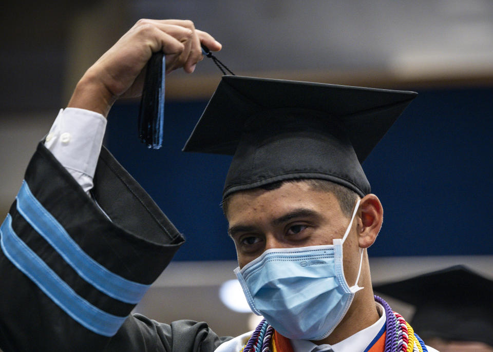 Odessa Collegiate Academy graduate Luis Leyva moves his tassel over during a graduation ceremony held at Odessa College Sports Center on Friday, May 21, 2021, in Odessa, Texas. (Eli Hartman/Odessa American via AP)