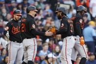 Baltimore Orioles' Cedric Mullins (31) celebrates his 3-run home run that also scored Austin Hays (21) and Jorge Mateo, right, during the third inning of a baseball game against the Boston Red Sox, Saturday, April 1, 2023, in Boston. (AP Photo/Michael Dwyer)