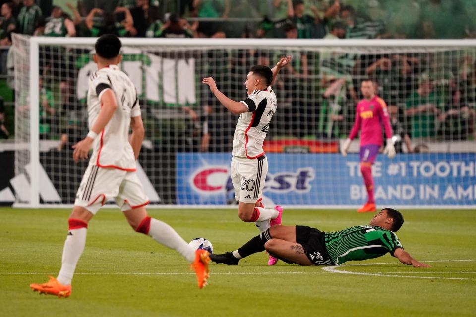 Austin FC forward Rodney Redes takes down FC Dallas forward Alan Velasco during Saturday's match. Rednes received a red card in the 54th minute, leaving El Tree with 10 players for the rest of the match.