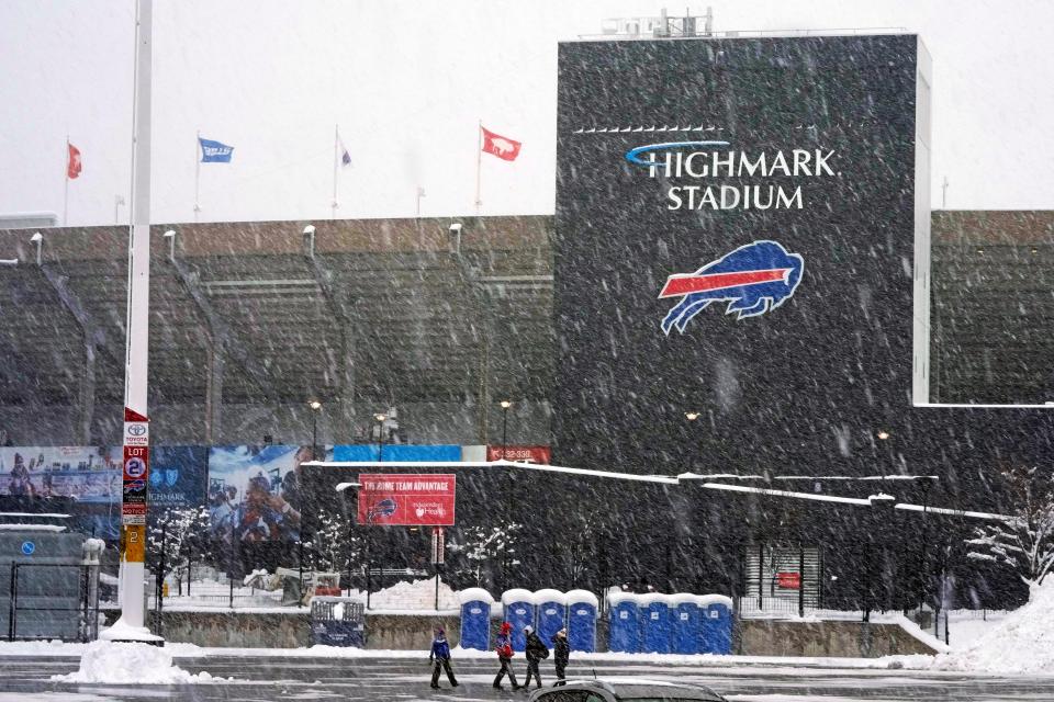 Fans arrive early Dec. 17, 2022, for an NFL game between the Buffalo Bills and the Miami Dolphins as snow falls at Highmark Stadium in Orchard Park, N.Y.