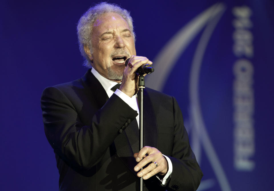 Welsh crooner Tom Jones performs during a gala dinner marking the end of the 16th annual Cigar Festival in Havana, Cuba, Friday, Feb. 28, 2014. The festival is a five-day bash that brings together hundreds of cigar sophisticates from around the world, and culminates with a gala and auction of humidors worth hundreds of thousands of dollars. Tom Jones was among the celebrity invitees at Saturday's auction and sang three songs for attending guests, including his signature "It's Not Unusual."(AP Photo/Franklin Reyes)