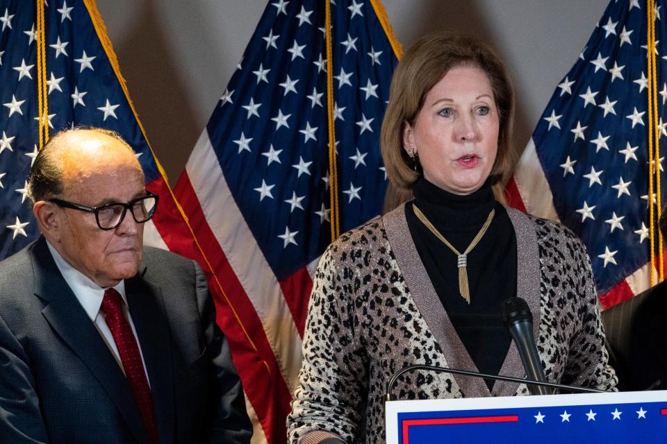 In this Nov. 19, 2020 file photo, Sidney Powell, right, speaks next to former Mayor of New York Rudy Giuliani, as members of President Donald Trump's legal team, during a news conference at the Republican National Committee headquarters in Washington. On Friday, June 4, 2021, The Associated Press reported on stories circulating online incorrectly asserting election technology firm Dominion Voting Systems lost its lawsuits against Powell and Giuliani. Dominion’s defamation lawsuits against the pair are ongoing, according to legal records.