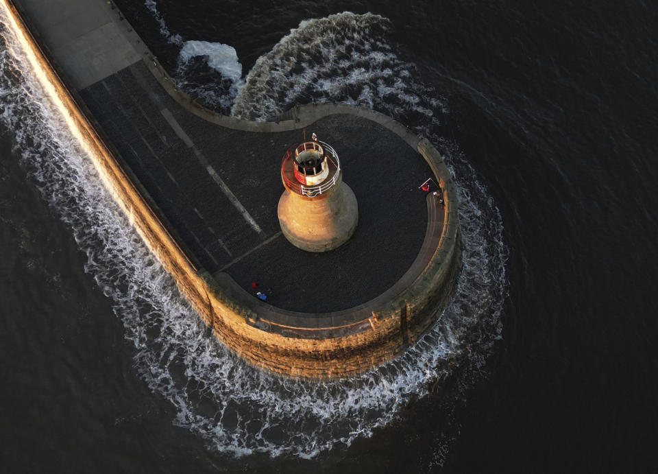 A view of South Shields lighthouse after the dome was ripped off, due to stormy weather, in South Shields, England, Sunday, Oct. 22, 2023. A storm battered Britain, northern Germany and southern Scandinavia for a third day with powerful winds, heavy rain and storm surges that caused floods, power outages, evacuations, and traffic disruptions. Since Thursday, at least four people have died in the storm, named Babet by the UK Meteorological Office. (Owen Humphreys/PA via AP)