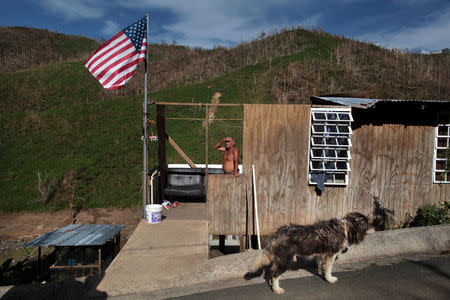 Ismael Rivera stands at his damaged house after Hurricane Maria destroyed the town's bridge in San Lorenzo, Morovis, Puerto Rico, October 4, 2017. REUTERS/Alvin Baez