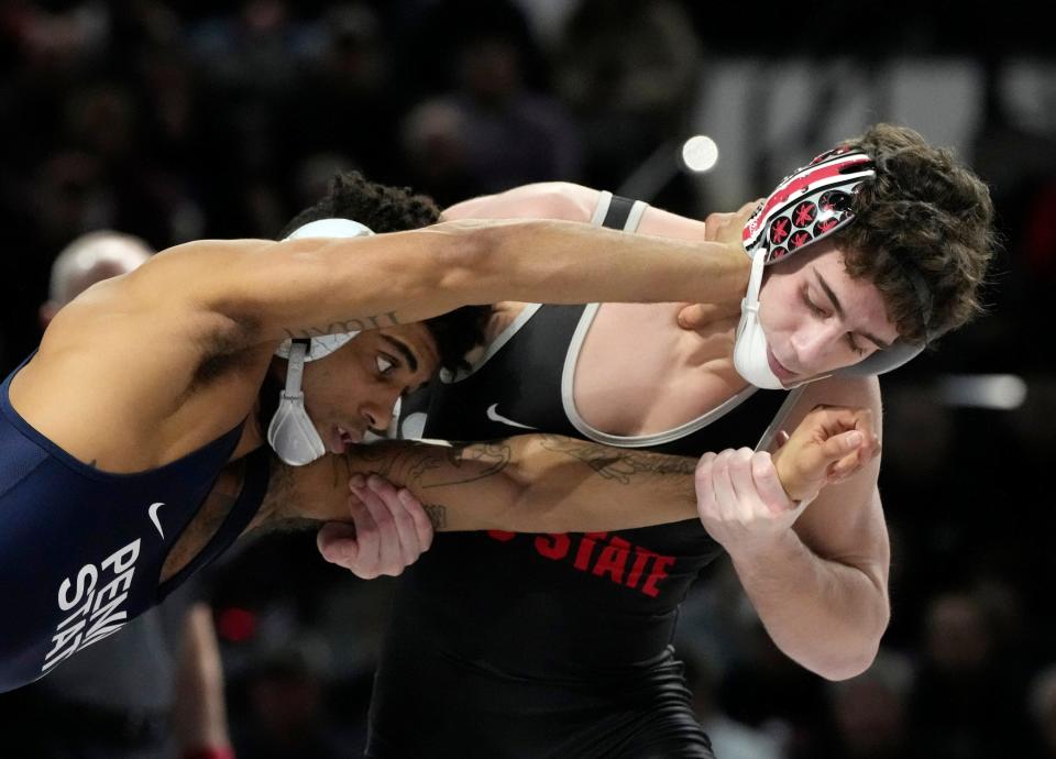 Jesse Mendez of Ohio State (right) battles Penn State's Roman Bravo-Young. Mendez, a freshman, is 12-2 and ranked in the top 10 in the nation at 133 pounds.