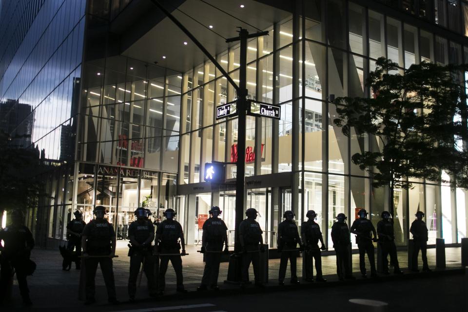 Police line the streets of lower Manhattan during an imposed curfew near where protesters were arrested for refusing to leave during a solidarity rally calling for justice over the death of George Floyd, Tuesday, June 2, 2020, in New York. Floyd died after being restrained by Minneapolis police officers on May 25. (AP Photo/Wong Maye-E)