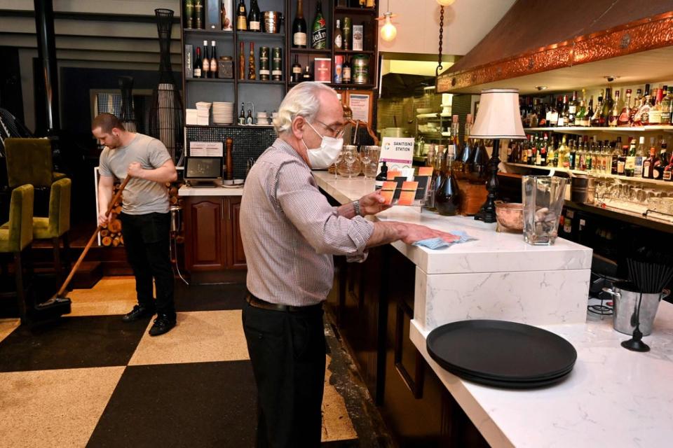 Restaurateur Tony Kay (R) prepares his establishment Copperwood for reopening in Melbourne (AFP via Getty Images)