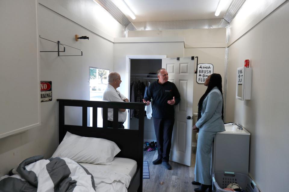 Joe Abdalla, executive director Code 3, talks with Dr. Rena Douse, CEO J.C. Lewis Primary Health Care Center and Michael G. Sarhatt, director CNT, inside the Opioid Awareness trailer on Monday November 28, 2022 during a visit to the J.C. Lewis Primary Healthcare Center. The inside of the trailer is set up to simulate a teen's bedroom and highlight some of the hidden warning signs of opioid abuse.