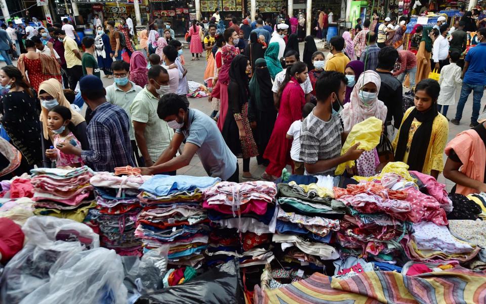 People crowd at a market area to shop after the government loosened a lockdown imposed as a preventive measure against the Covid-19 coronavirus ahead of the Muslim festival of Eid al-Adha in Dhaka on July 16, 2021.  - AFP