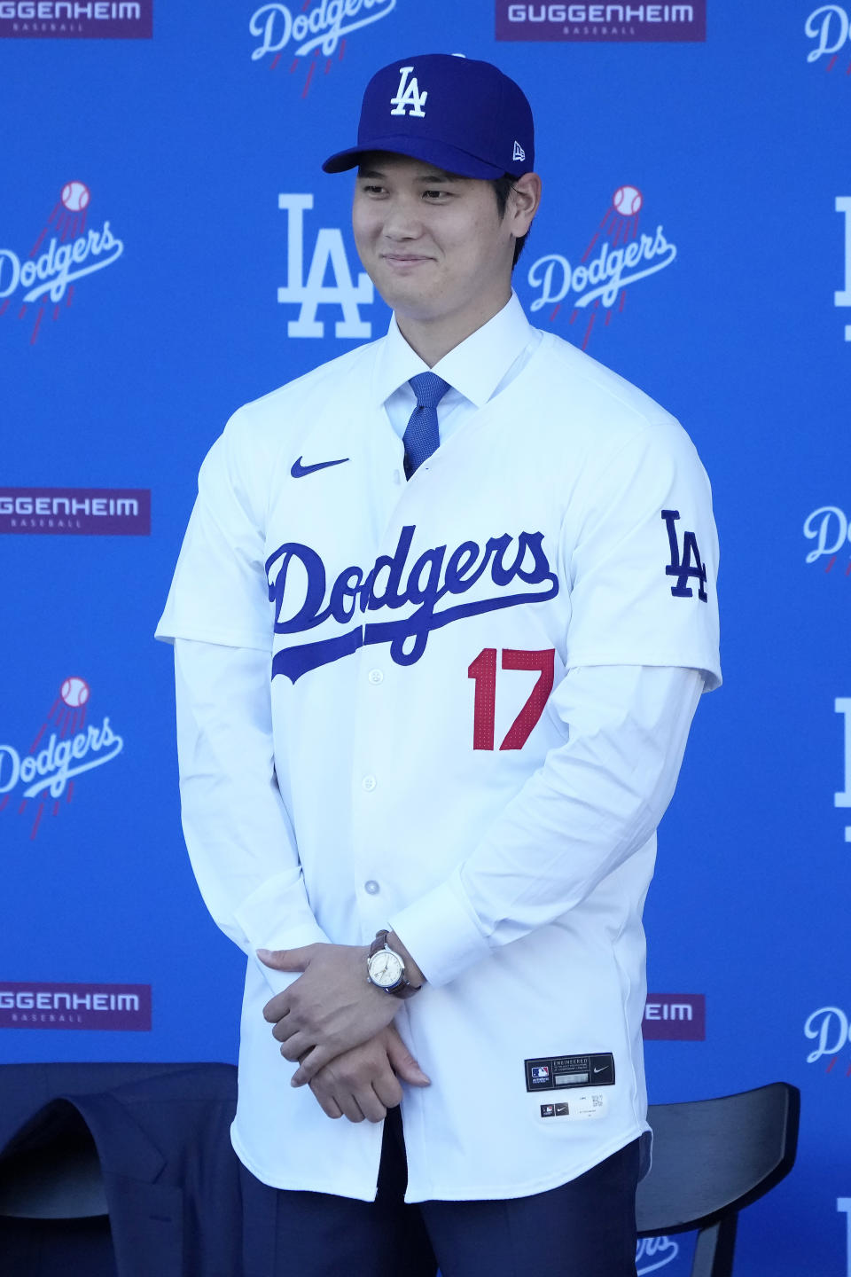 Los Angeles Dodgers' Shohei Ohtani stands in a jersey and baseball cap during a news conference at Dodger Stadium Thursday, Dec. 14, 2023, in Los Angeles. (AP Photo/Marcio Jose Sanchez)