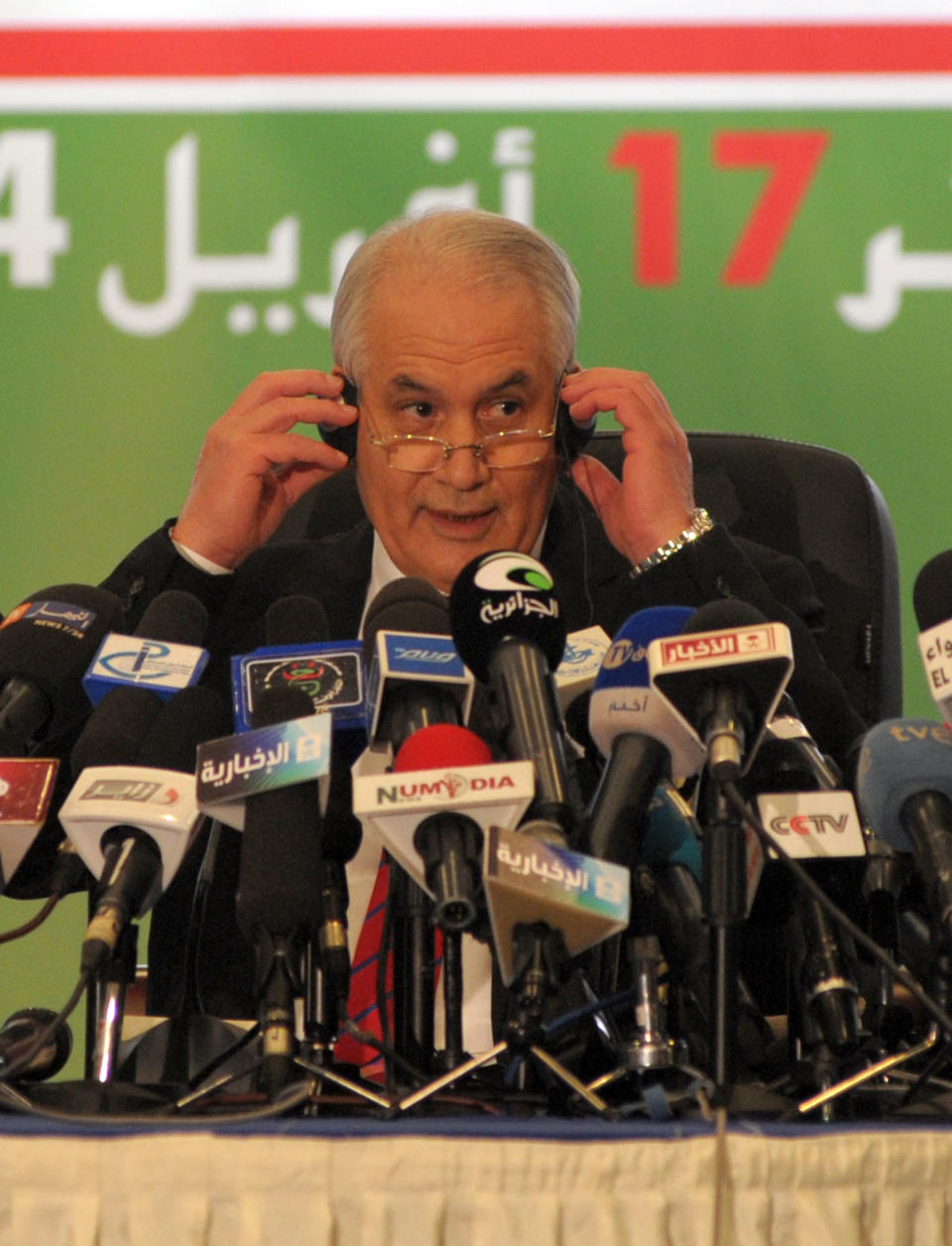 Interior Minister, Taieb Belaiz, adjusts his earphones as he announces the results of the presidential elections during a press conference held in Algiers, Friday, April 18, 204. President Abdelaziz Bouteflika won a fourth term in office with a landslide 81 percent of the vote, according to preliminary figures announced by the Algerian government Friday. His chief opponent, Ali Benflis, who garnered only 12 percent of the vote, has already criticized the election as marked by “fraud on a massive scale” after polls closed Thursday and vowed not to accept the results. (AP Photo/Sidali Djarboub )