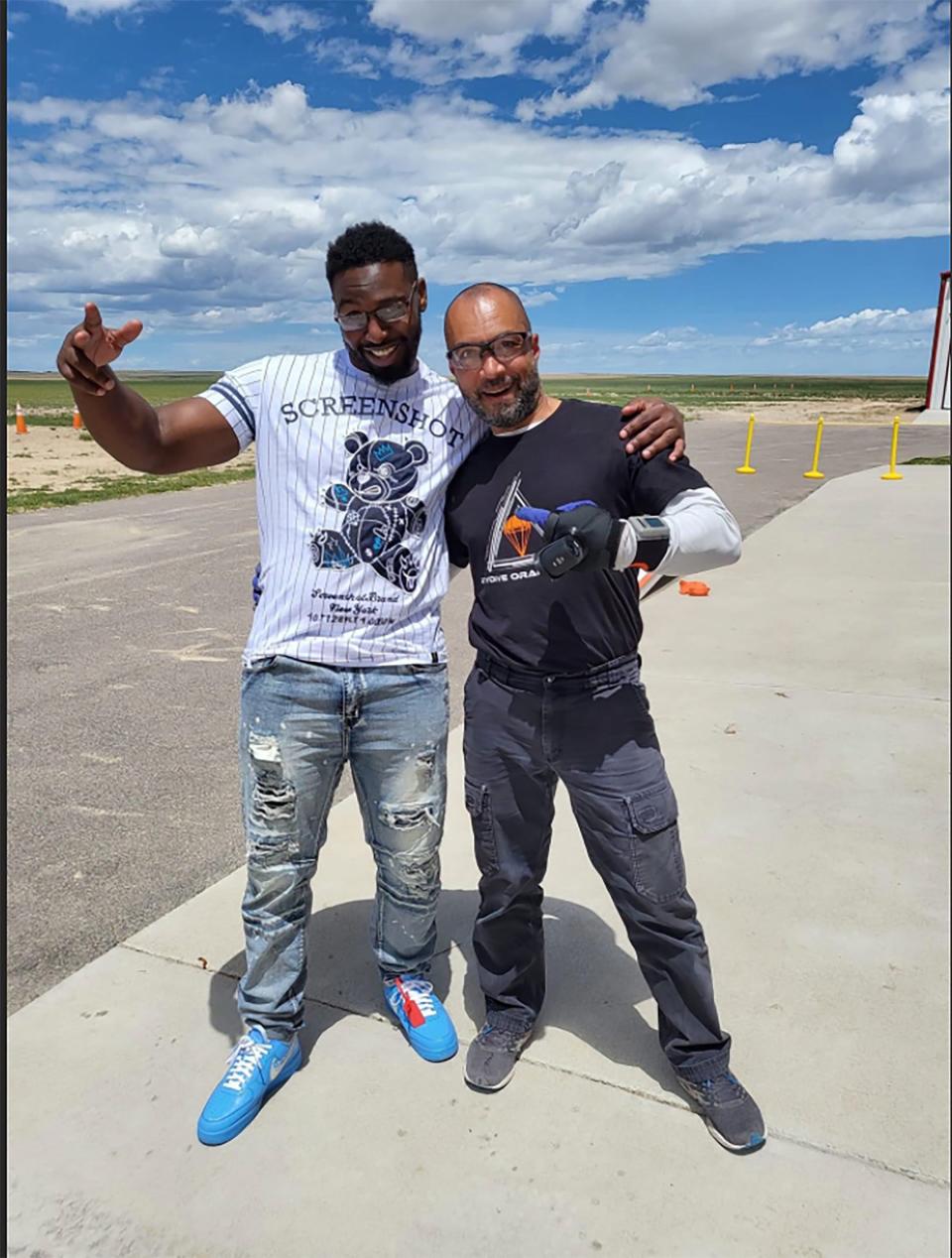 Marlin Dixon, left, poses with his skydiving instructor after jumping from a plane in Colorado in June. Dixon who went to Denver to visit Vicki Conte, his friend and supporter.