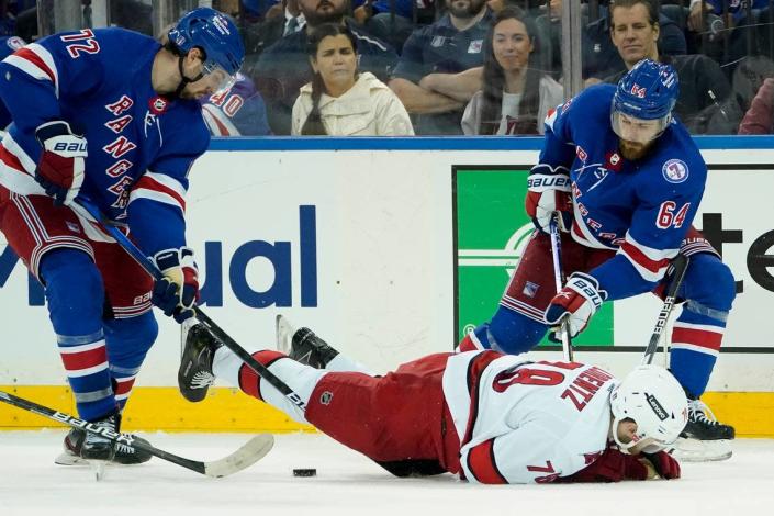 Carolina Hurricanes center Steven Lorentz (78) falls on a play against New York Rangers center Tyler Motte (64) and center Filip Chytil (72) in the third period of Game 4 of an NHL hockey Stanley Cup second-round playoff series, Tuesday, May 24, 2022, in New York. The Rangers won 4-1.