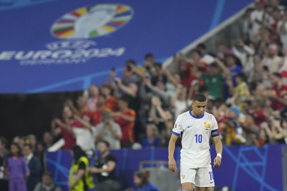 France's Kylian Mbappe walks in dejection after Spain's Dani Olmo scores his side's second goal during a semifinal match between Spain and France at the Euro 2024 soccer tournament in Munich, Germany, Tuesday, July 9, 2024. (AP Photo/Hassan Ammar)