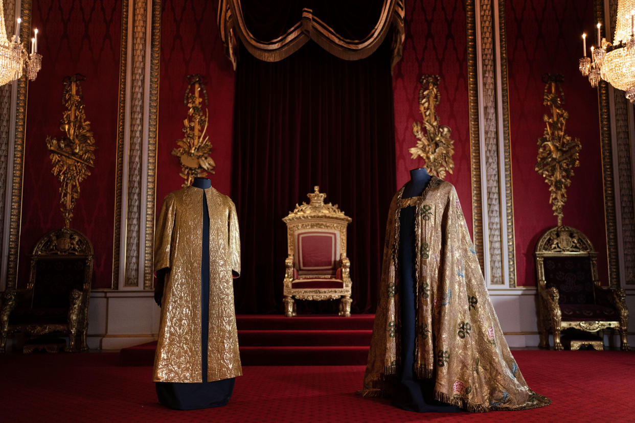 Coronation accessories such as vestments are displayed in the Throne Room at Buckingham Palace.