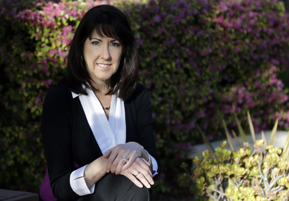 Pamela Mahoney poses for a portrait at home on Thursday, March 13, 2014, in Los Gatos, Calif. Mahoney decided to leave a job in corporate communications and join her husband full-time in the communications company, BlueChair Group Inc., they co-founded. They recently chose an insurance plan for $1,100 a month on the California marketplace: "Prior to the Affordable Care Act, I felt bound to be an employee rather than a small business owner," said Mahoney. (AP Photo/Marcio Jose Sanchez)